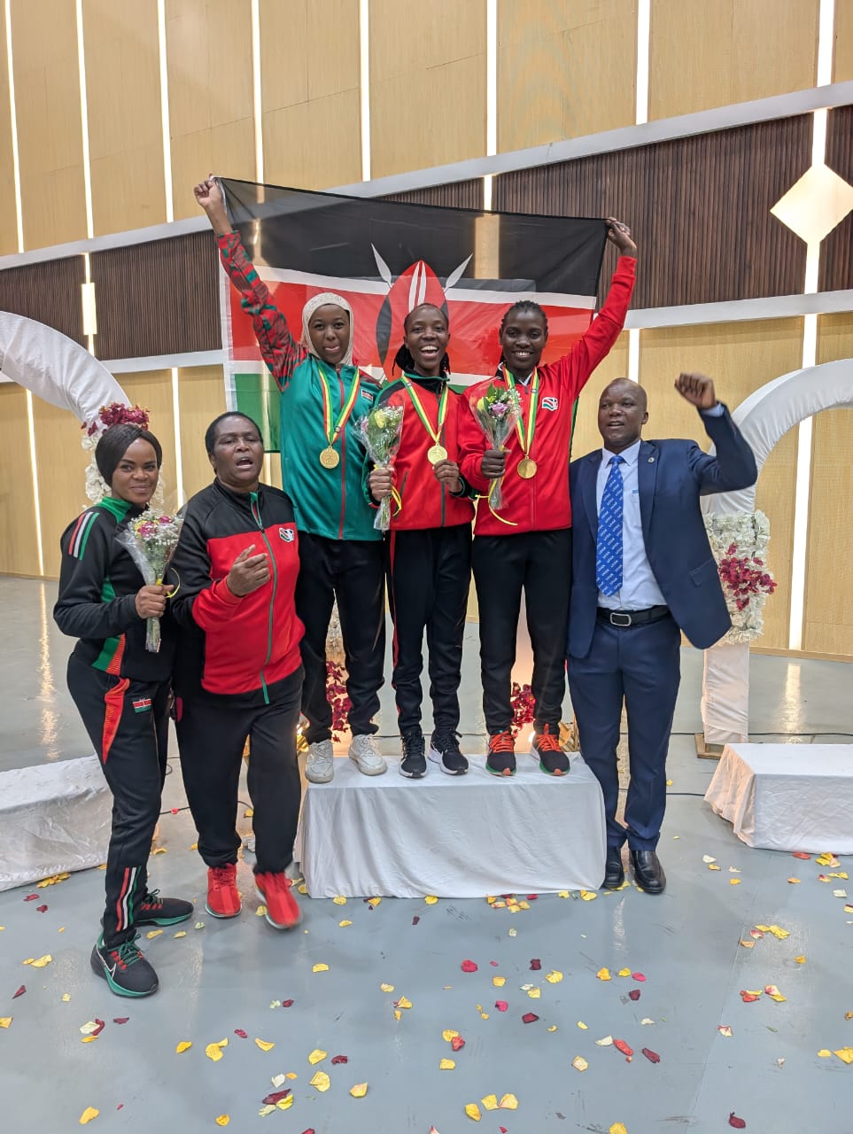 Kenya’s women’s team celebrates a well-earned victory alongside Federation President Eng. Richard Binga and their coaches.